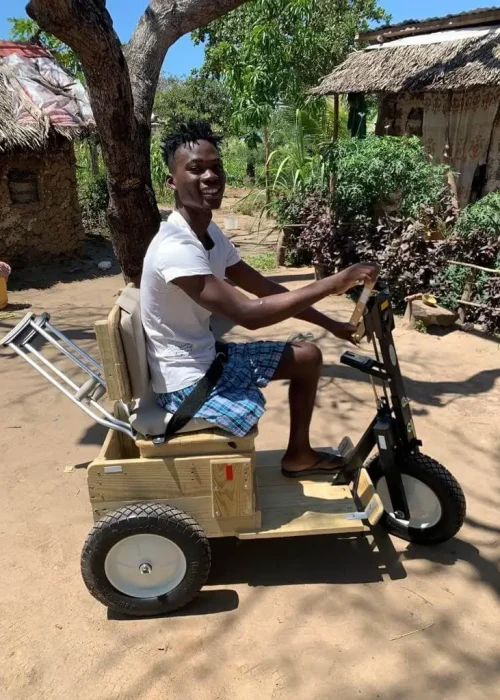 Kenya-PFC-man-young-missing-leg-w-on-cart-2021